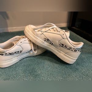 Woman’s size 5 1/2 white Reeboks shoes with leopard white snow leopard accent